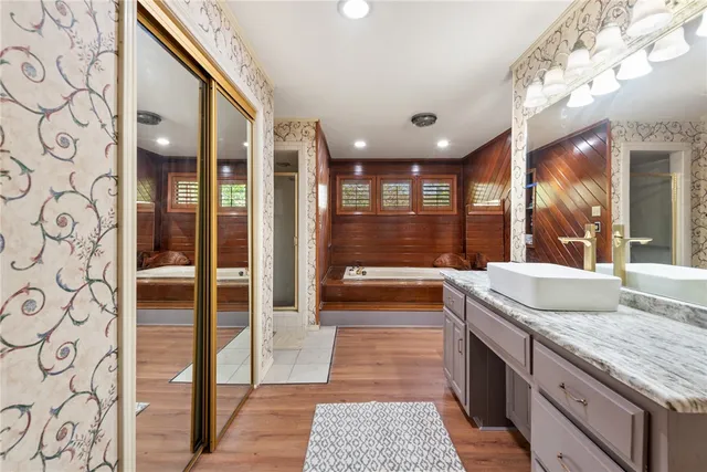 a bathroom with a granite countertop sink a toilet and shower
