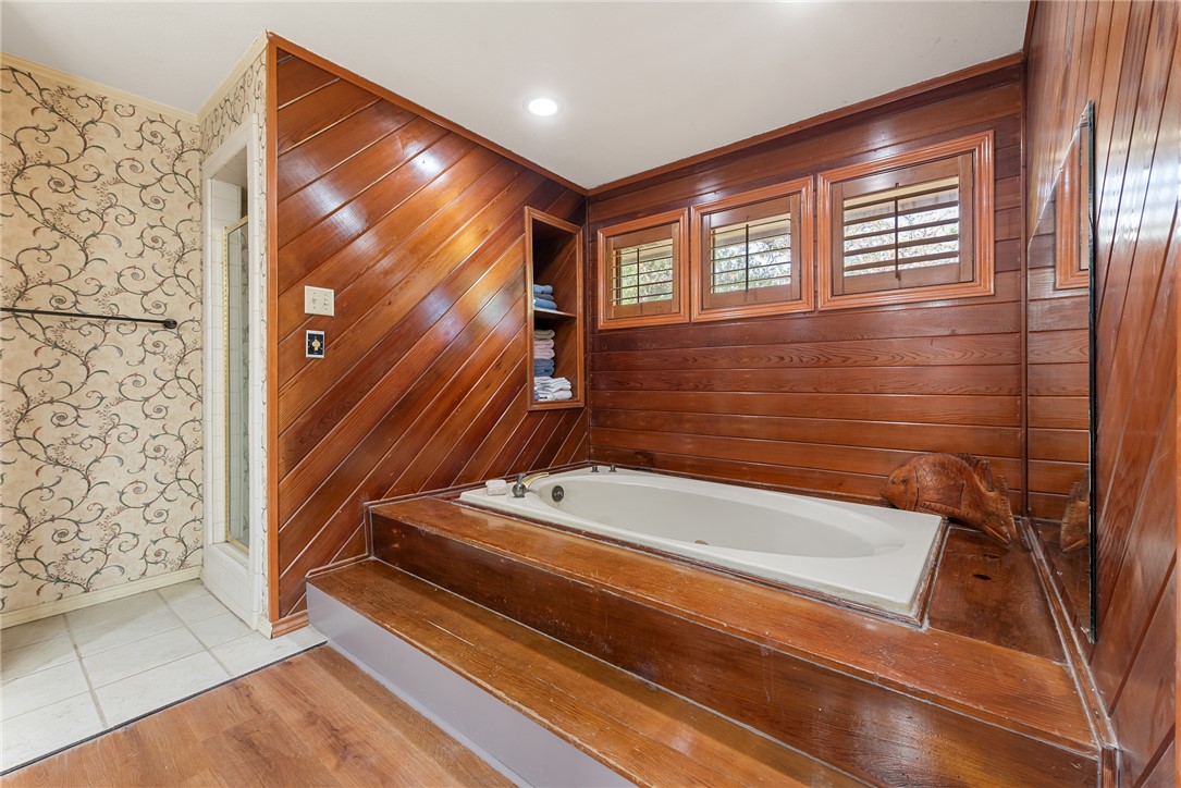 1309 Rock Dam Road Marlin, TX 76661 - Photo 29 of 50 Bathroom with crown molding, a bath, a shower with door, wallpapered walls, and baseboards