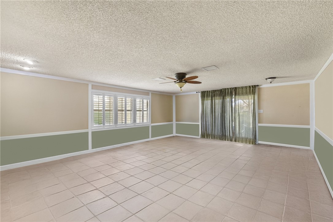 1309 Rock Dam Road Marlin, TX 76661 - Photo 32 of 50 Spare room featuring baseboards, ornamental molding, light tile patterned floors, a textured ceiling, and ceiling fan