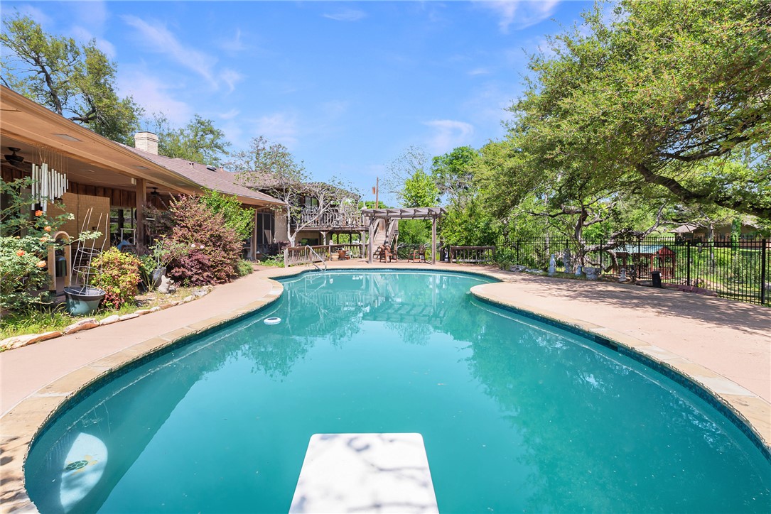1309 Rock Dam Road Marlin, TX 76661 - Photo 37 of 50 View of swimming pool with a pergola, a diving board, fence, and a fenced in pool