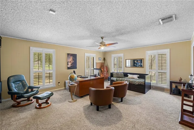 an aerial view of a house with a yard and outdoor seating