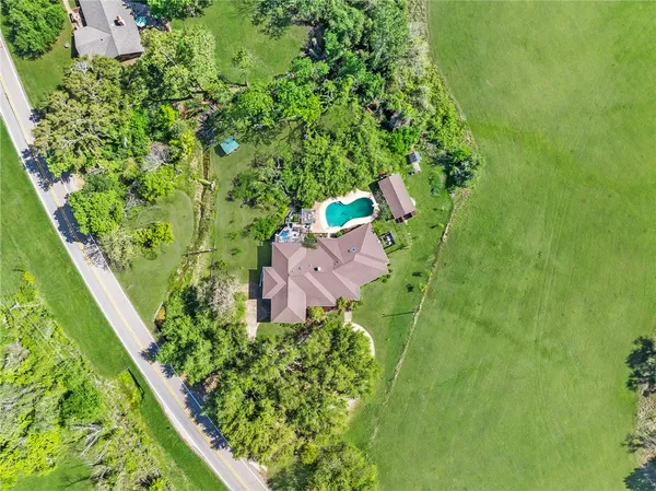 an aerial view of a house with a yard