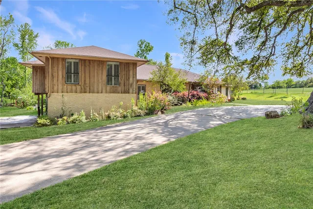 a front view of a house with garden