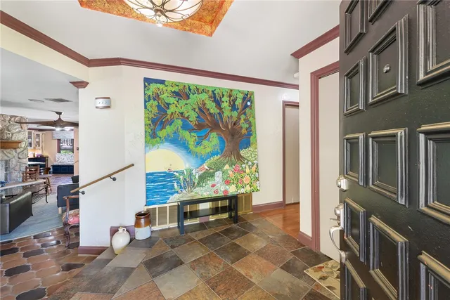 a very nice looking room with a large window and potted plants