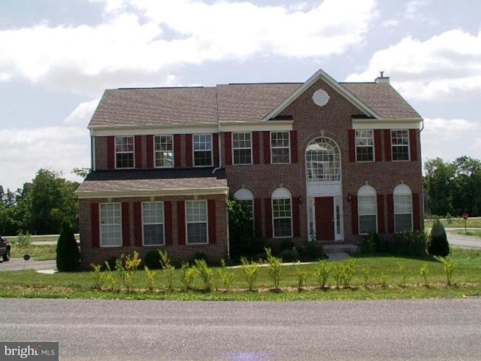 8 Marblehead Road Inwood, WV 25428 - Photo 1 of 18 a front view of a house with a yard and potted plants