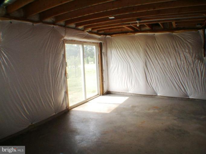 8 Marblehead Road Inwood, WV 25428 - Photo 13 of 18 a view of empty room with wooden floor and fan