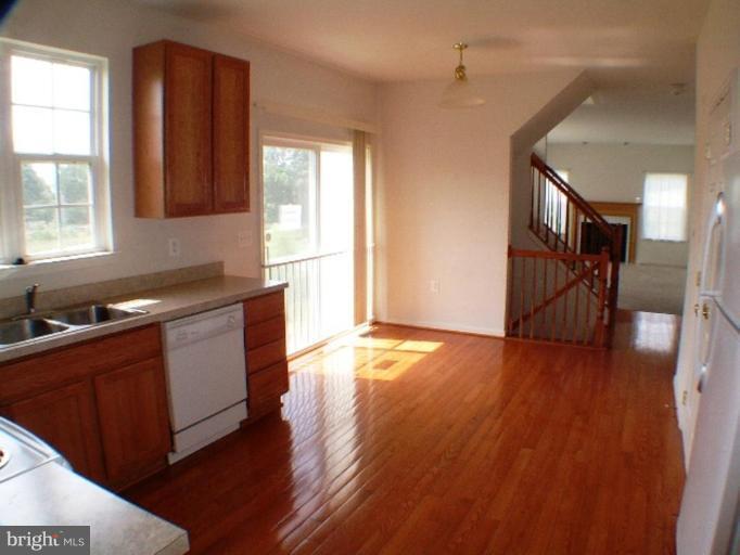 8 Marblehead Road Inwood, WV 25428 - Photo 18 of 18 a kitchen with granite countertop wooden floors and wide window