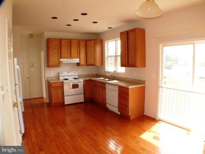 8 Marblehead Road Inwood, WV 25428 - Photo 3 of 18 a kitchen with stainless steel appliances granite countertop a stove a sink and a refrigerator