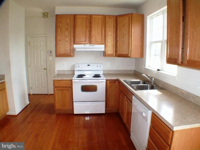8 Marblehead Road Inwood, WV 25428 - Photo 4 of 18 a kitchen with a sink a stove and cabinets