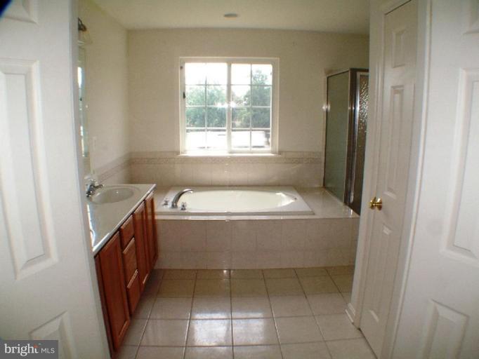 8 Marblehead Road Inwood, WV 25428 - Photo 8 of 18 a bathroom with a bathtub sink and toilet