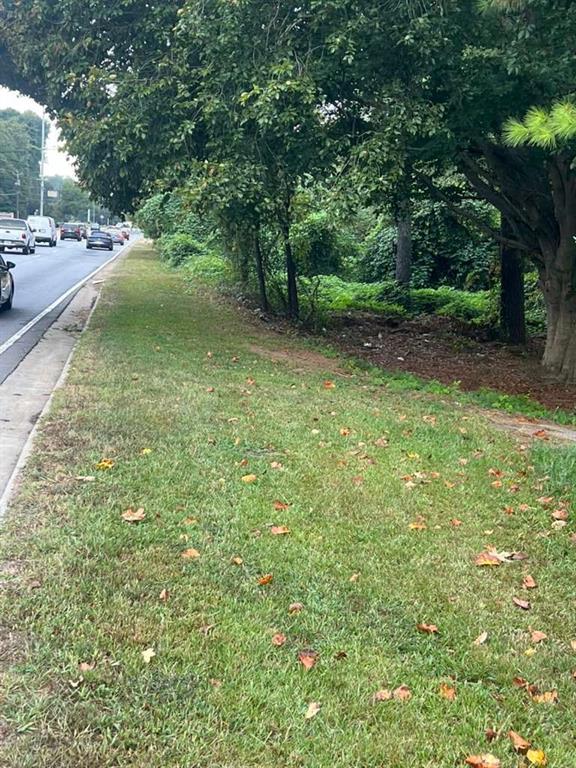 5160 Covington Highway Decatur, GA 30035 - Photo 5 of 7 a view of a yard with potted plants and large trees