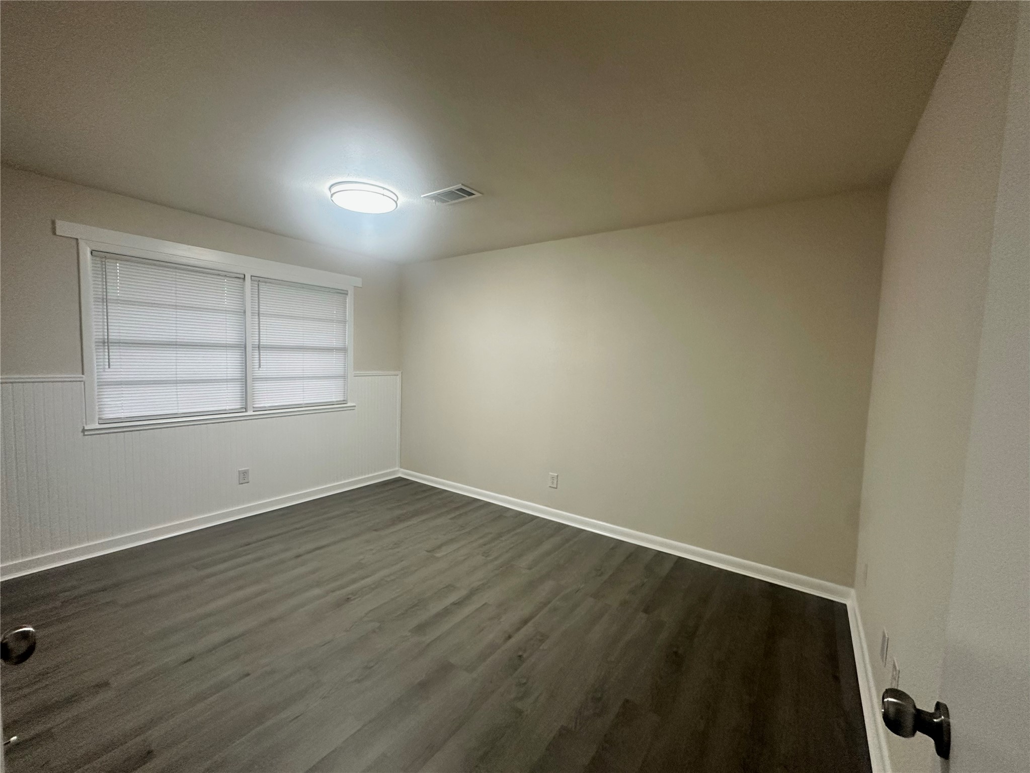 130 Bay Ridge Drive Baytown, TX 77523 - Photo 13 of 20 This room features neutral walls, flooring, and a large window with blinds, creating a bright and versatile space.