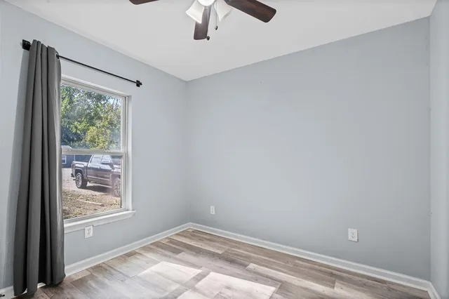 a view of room with window and ceiling fan