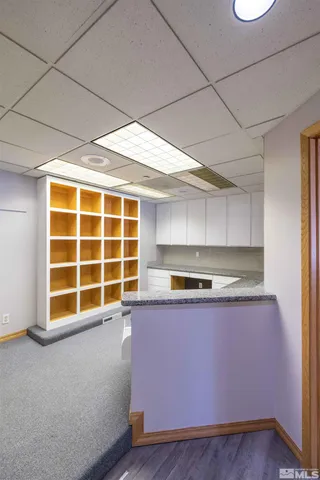 a view of a kitchen with wooden floor and a large window