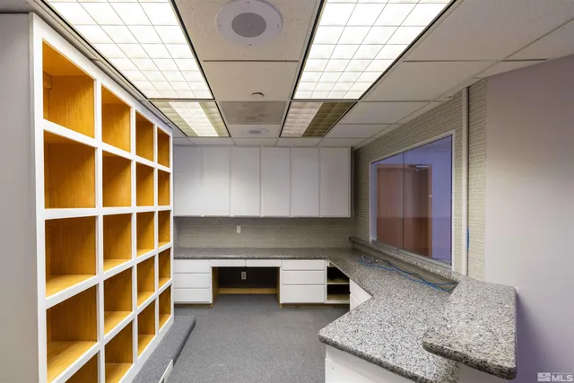 a living room with stainless steel appliances granite countertop furniture and a fireplace