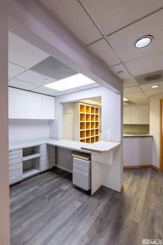 a room with wooden floors and white walls