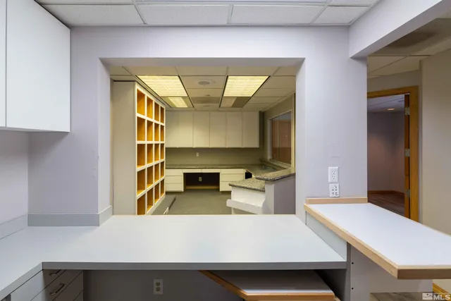 a living room with kitchen island furniture and a table