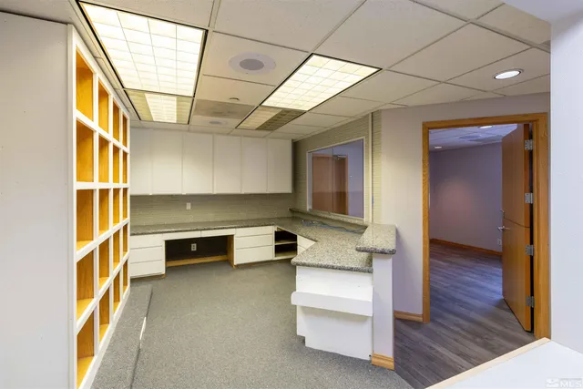 a hallway with a white furniture and wooden floor