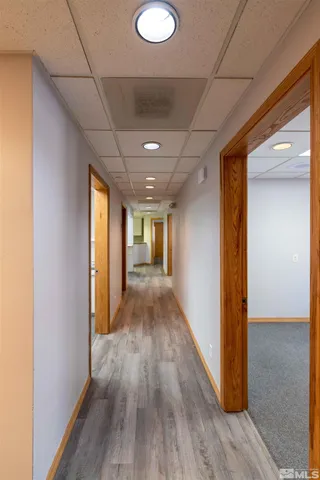 a view of hallway with wooden floor