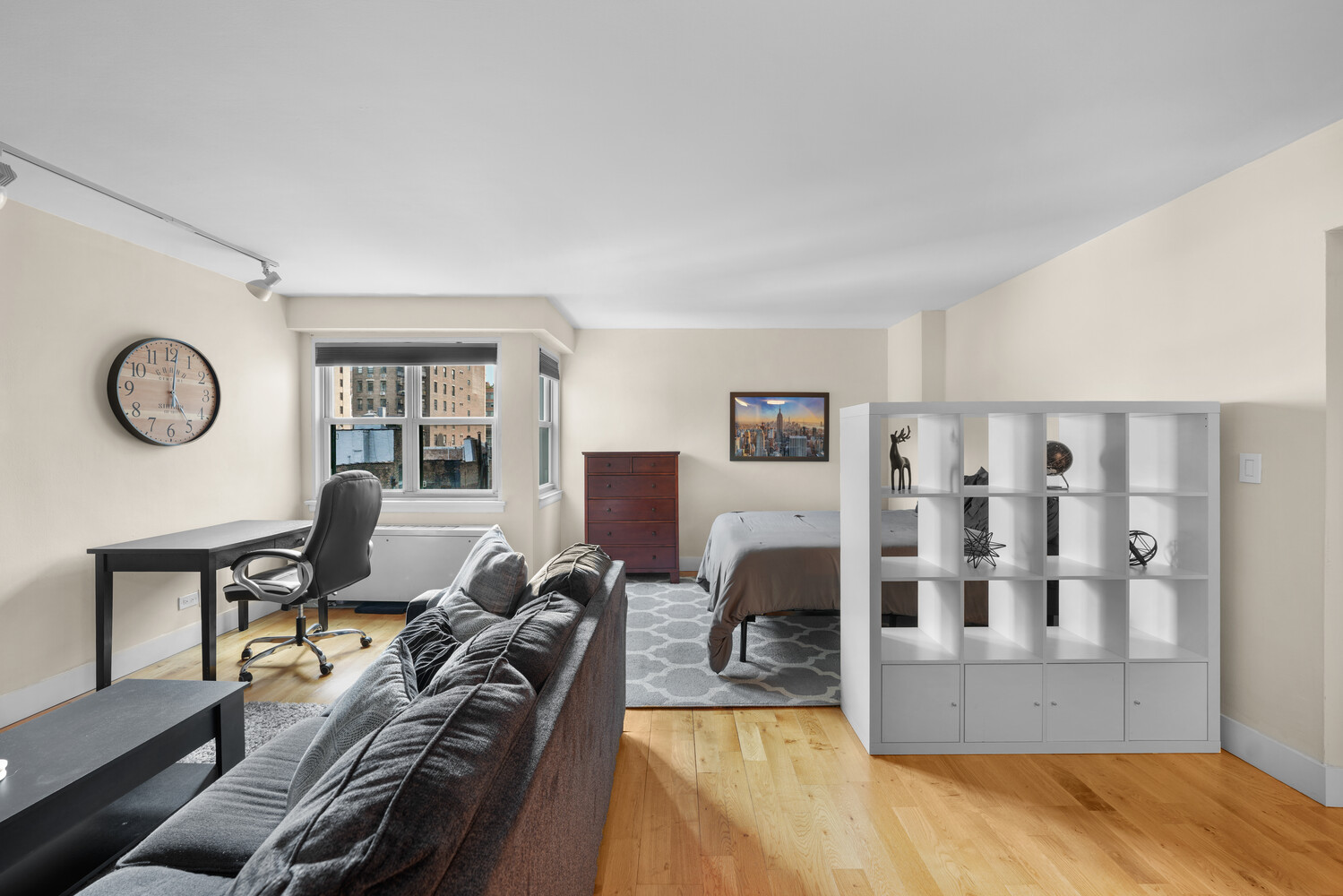101 West 12th Street, Unit 9Z Manhattan, NY 10011 - Photo 2 of 15 a living room with furniture a rug and white walls