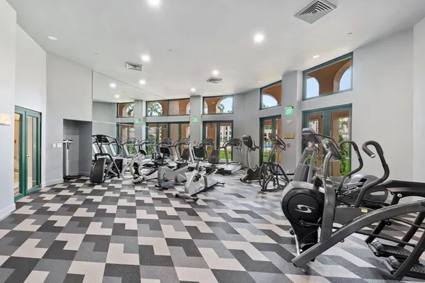 a view of a room with lots of gym equipment