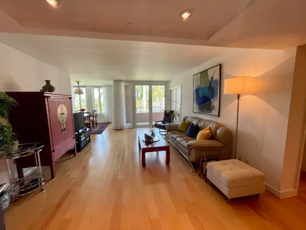 a living room with furniture flat screen tv and wooden floor