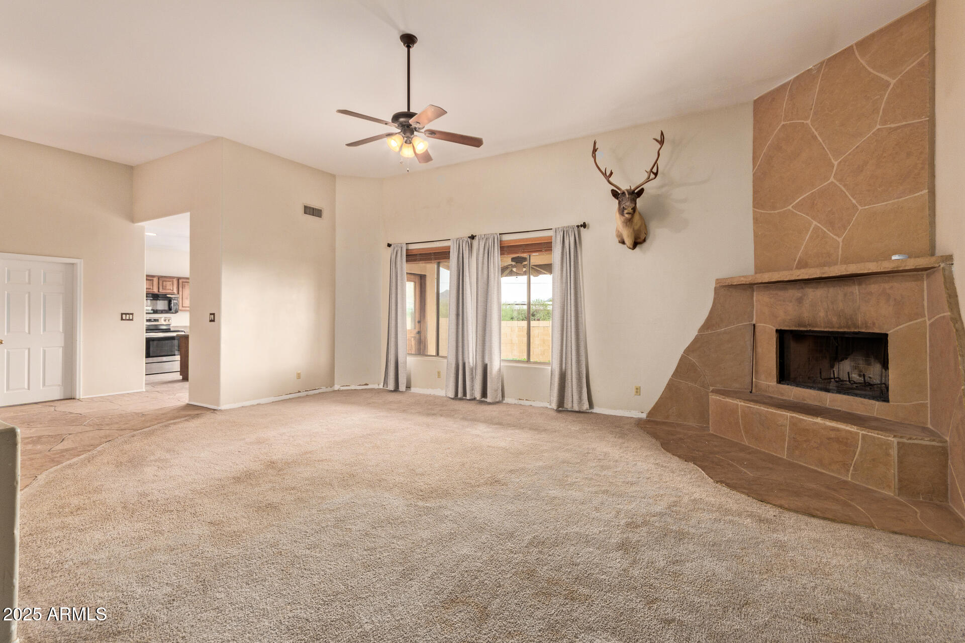 1032 East Carlise Road Phoenix, AZ 85086 - Photo 11 of 56 a view of an empty room with a fireplace and a window