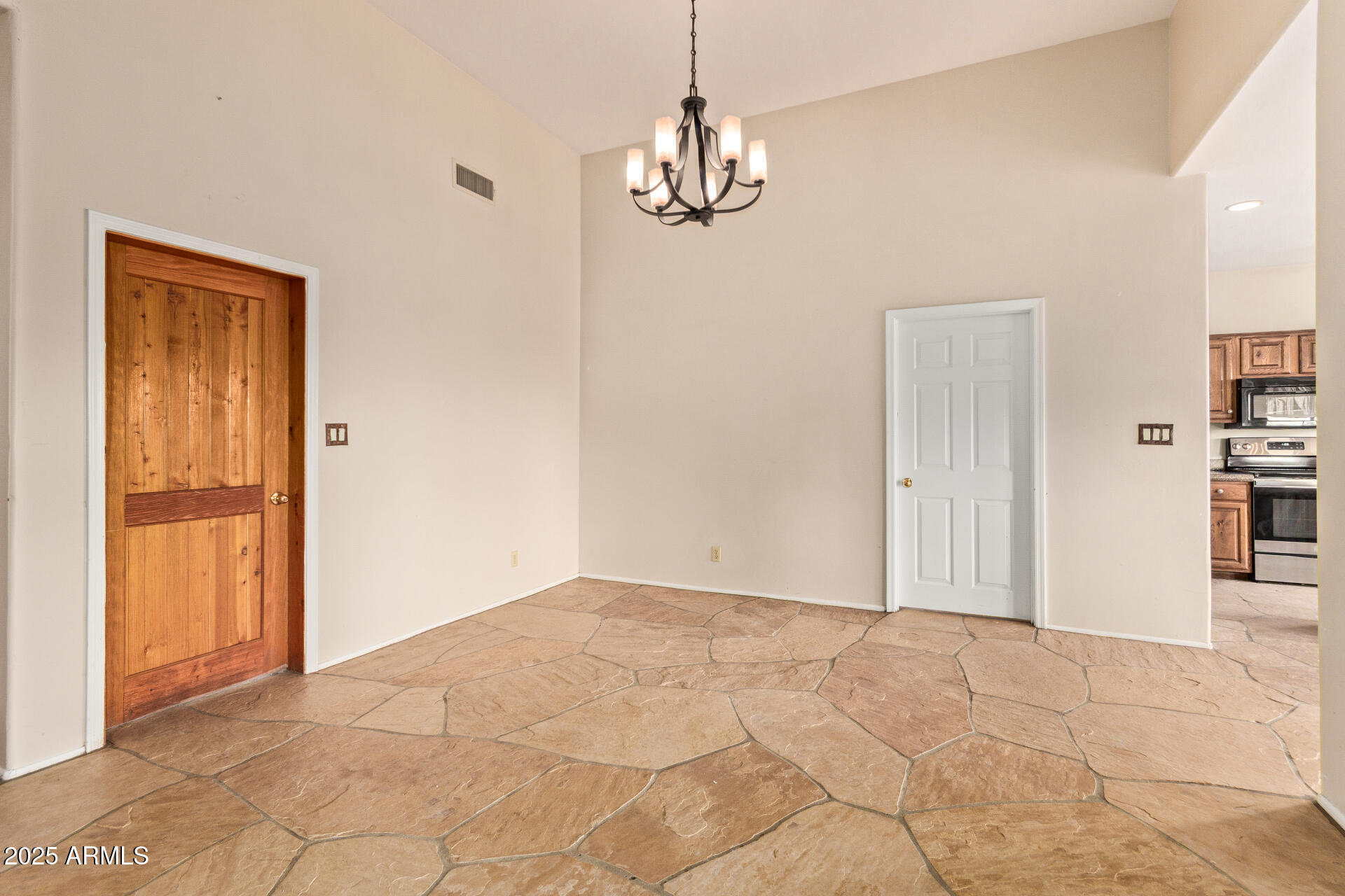 1032 East Carlise Road Phoenix, AZ 85086 - Photo 13 of 56 a view of a livingroom with wooden floor and a chandelier