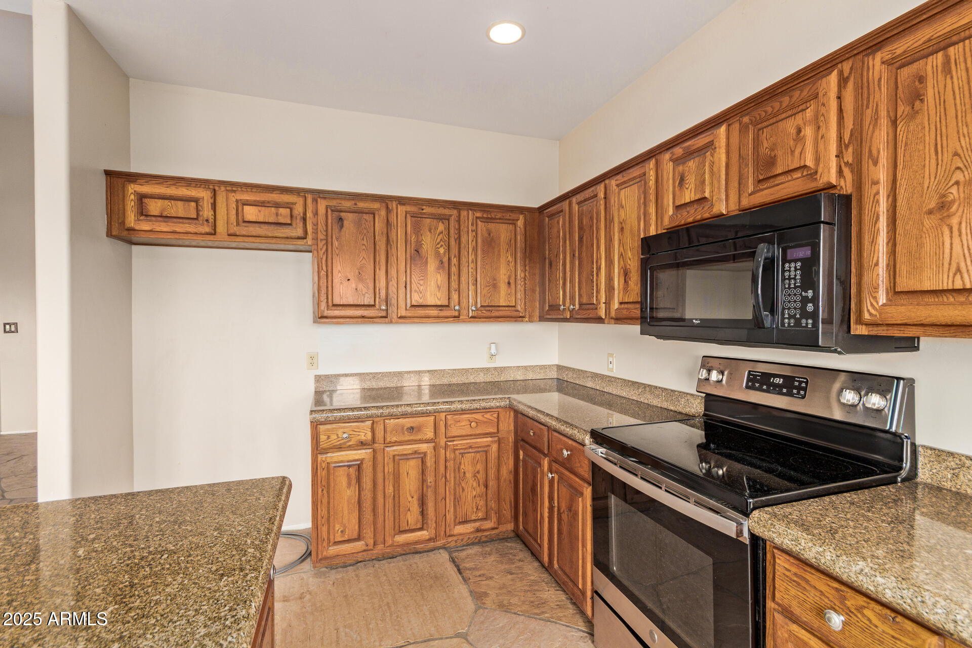 1032 East Carlise Road Phoenix, AZ 85086 - Photo 18 of 56 a kitchen with granite countertop a stove top oven microwave and cabinets