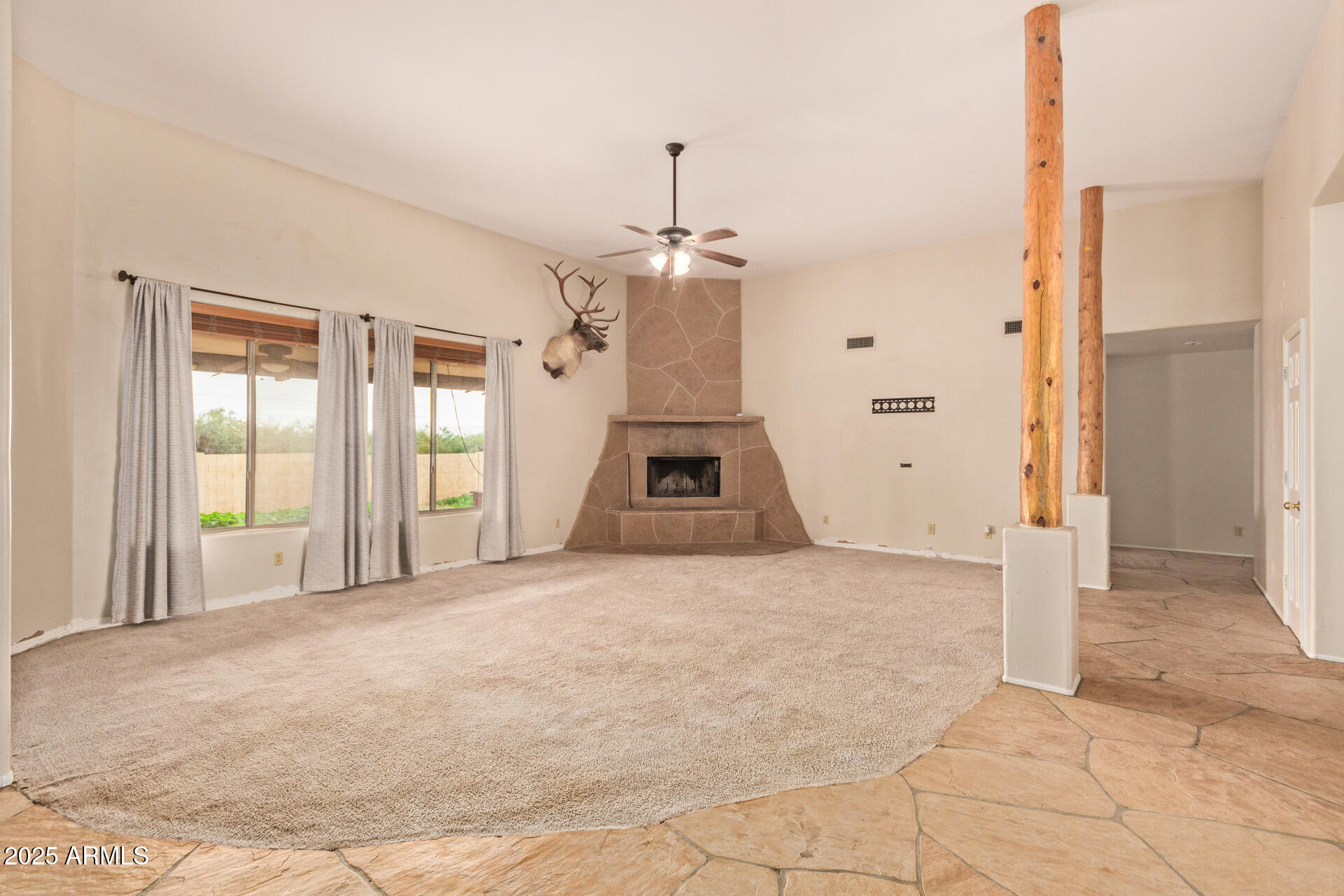 1032 East Carlise Road Phoenix, AZ 85086 - Photo 9 of 56 a view of a livingroom with wooden floor and a ceiling fan