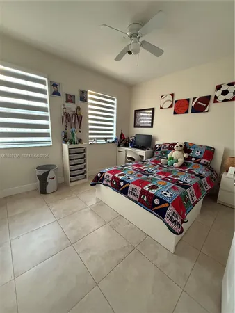a spacious bathroom with a granite countertop sink a toilet a mirror and tub