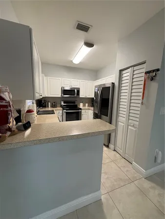 a kitchen with a sink stainless steel appliances and cabinets