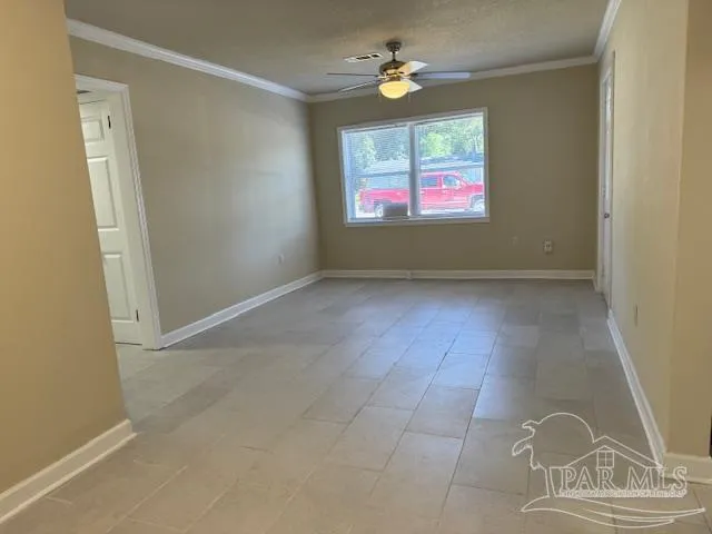 en empty room with windows chandelier and fireplace