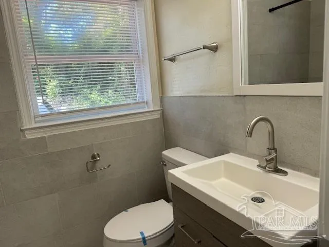 a bathroom with a sink toilet and a mirror