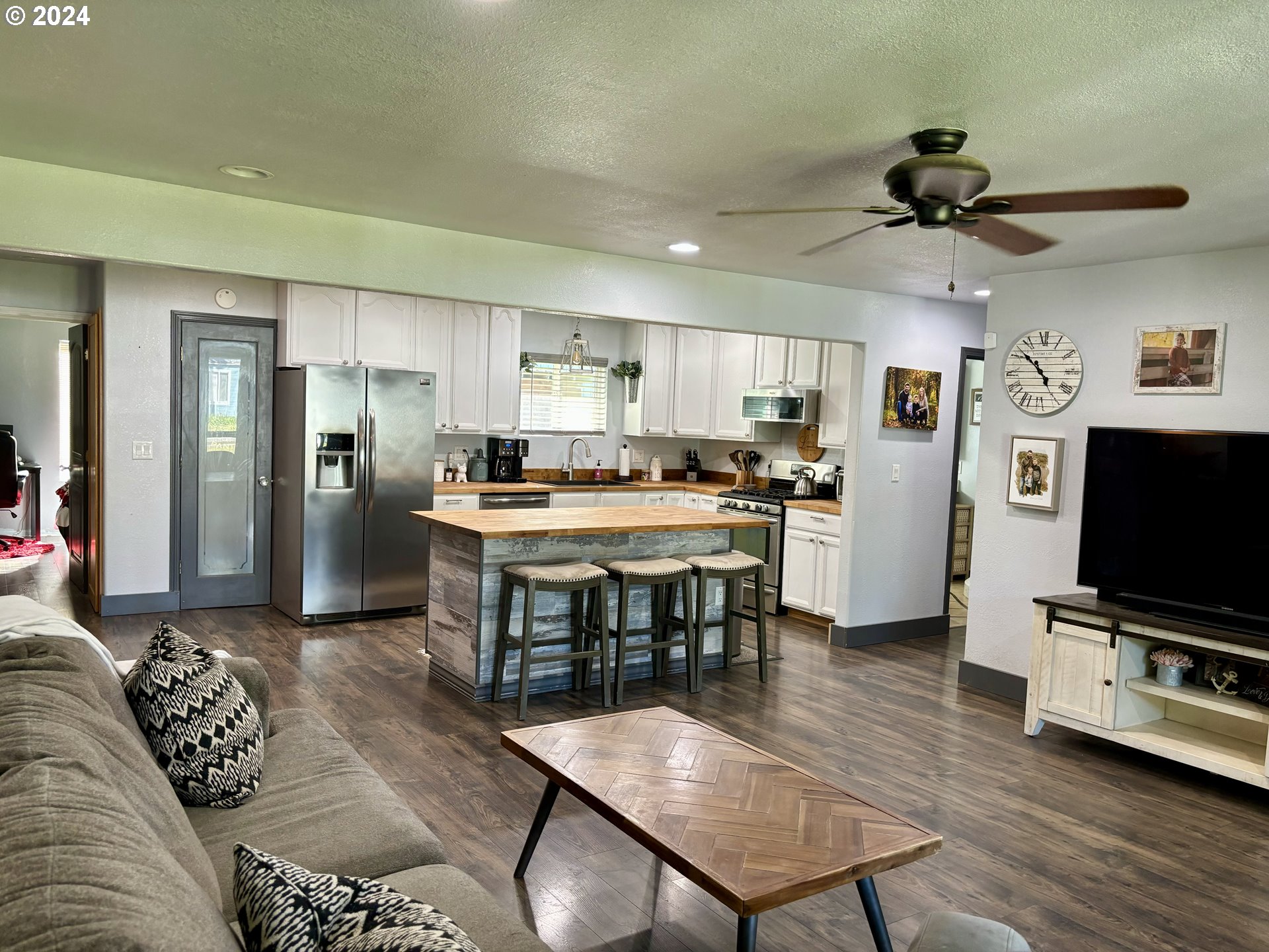 154 Park Street Riddle, OR 97469 - Photo 2 of 24 a living room with stainless steel appliances furniture a flat screen tv and kitchen view