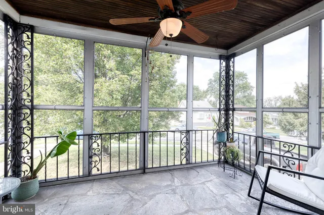 a view of a porch with wooden floor in front of a house