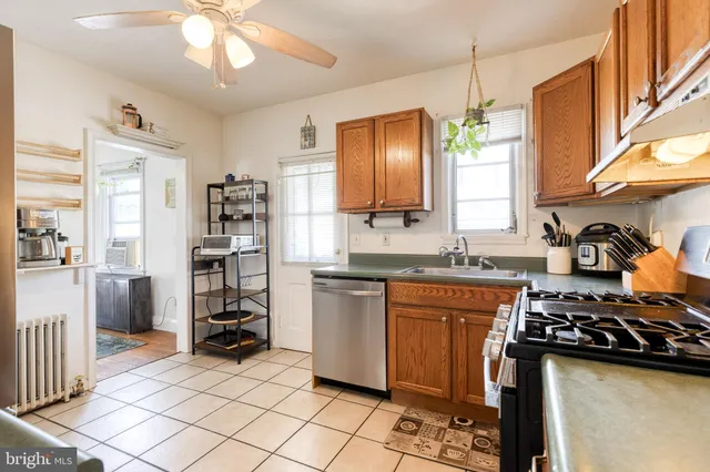 a kitchen with stainless steel appliances a stove a sink and a refrigerator