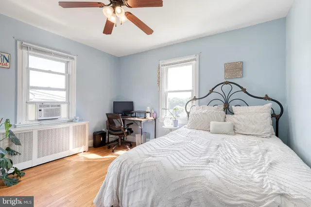 a bedroom with a large bed and a window