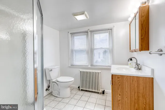 a bathroom with a sink toilet and a mirror