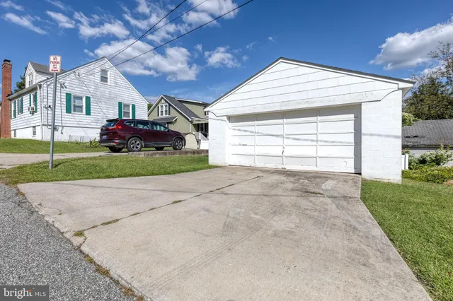 a view of a house with a yard and garage
