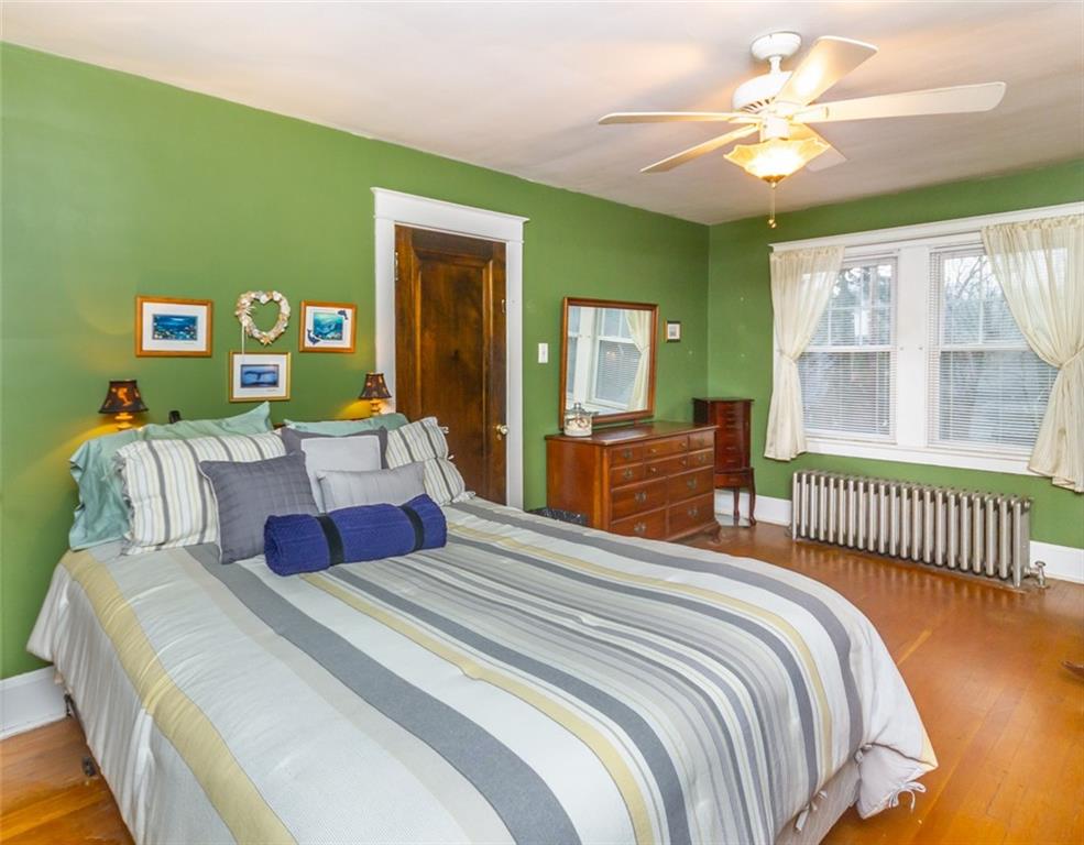 644 Cascade Road Pittsburgh, PA 15221 - Photo 13 of 21 a bedroom with a bed and a chandelier