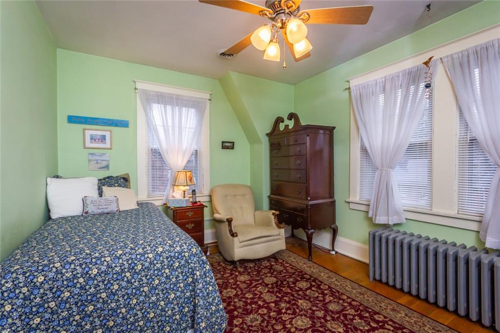 644 Cascade Road Pittsburgh, PA 15221 - Photo 14 of 21 a bedroom with a bed and wooden floor