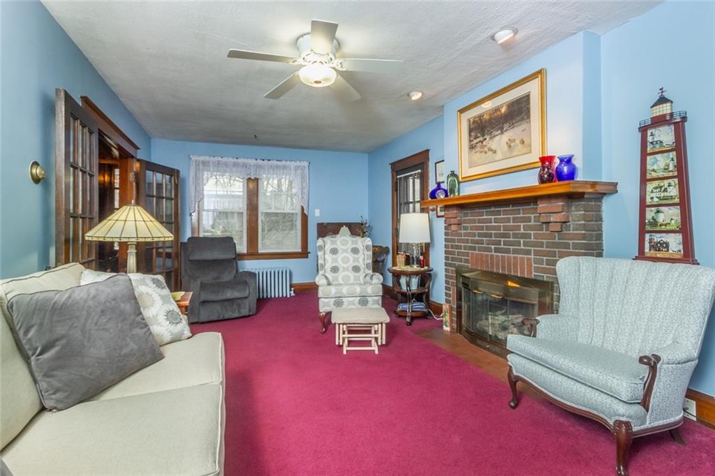 644 Cascade Road Pittsburgh, PA 15221 - Photo 5 of 21 a living room with furniture and a fireplace