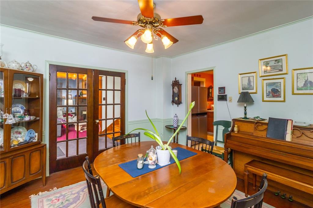 644 Cascade Road Pittsburgh, PA 15221 - Photo 8 of 21 a living room with furniture a flat screen tv and a chandelier