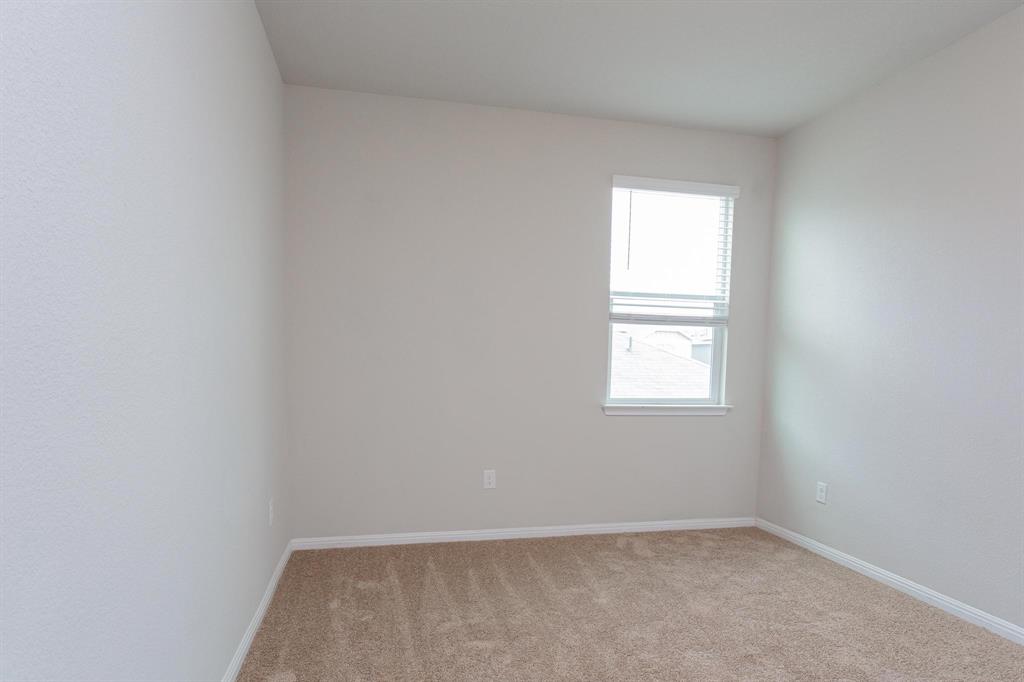 14614 Frankel Loop Pflugerville, TX 78660 - Photo 9 of 15 Well-lit and tranquil, this inviting bedroom offers comfortable carpet flooring and a single window.