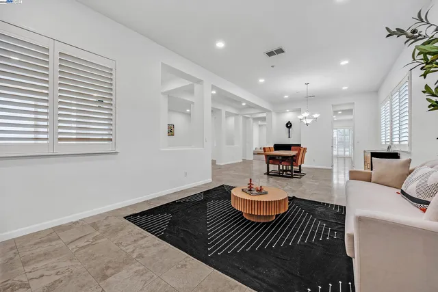 a large white kitchen with granite countertop a sink