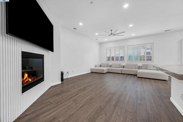 a view of empty room with wooden floor and fireplace
