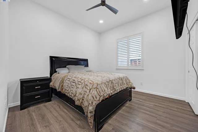 a view of room with a piano and wooden floor