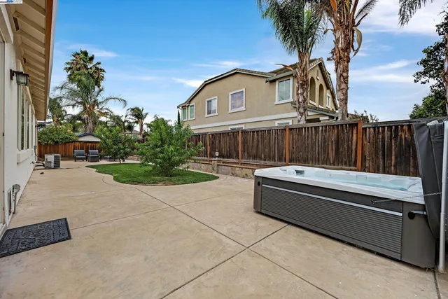 a front view of a house with a yard and potted plants