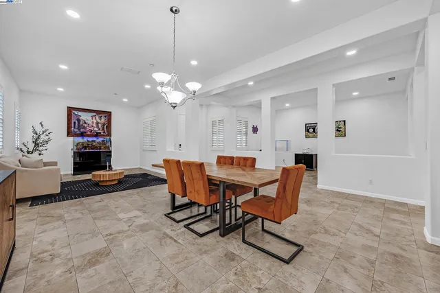 a dining room with a table and chairs